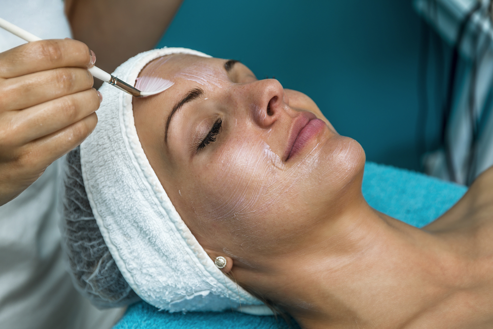 Patient having a chemical peel applied to her face for smoother, brighter skin.