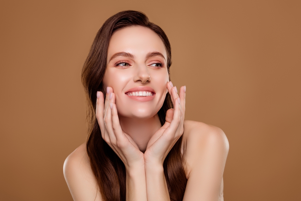 Woman smiling with smooth skin after Botox maintenance treatment.